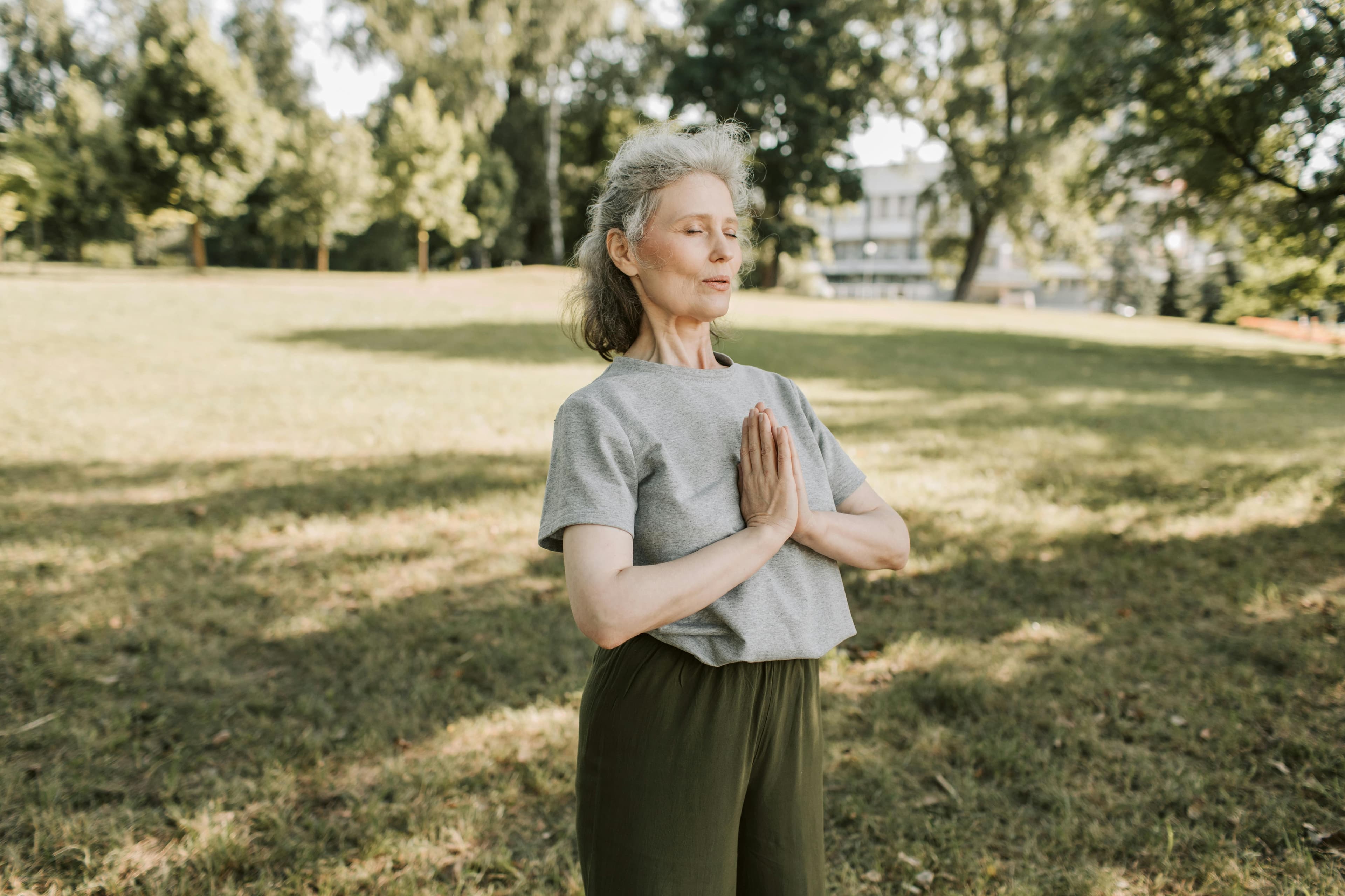 Woman meditating peacefully in a park