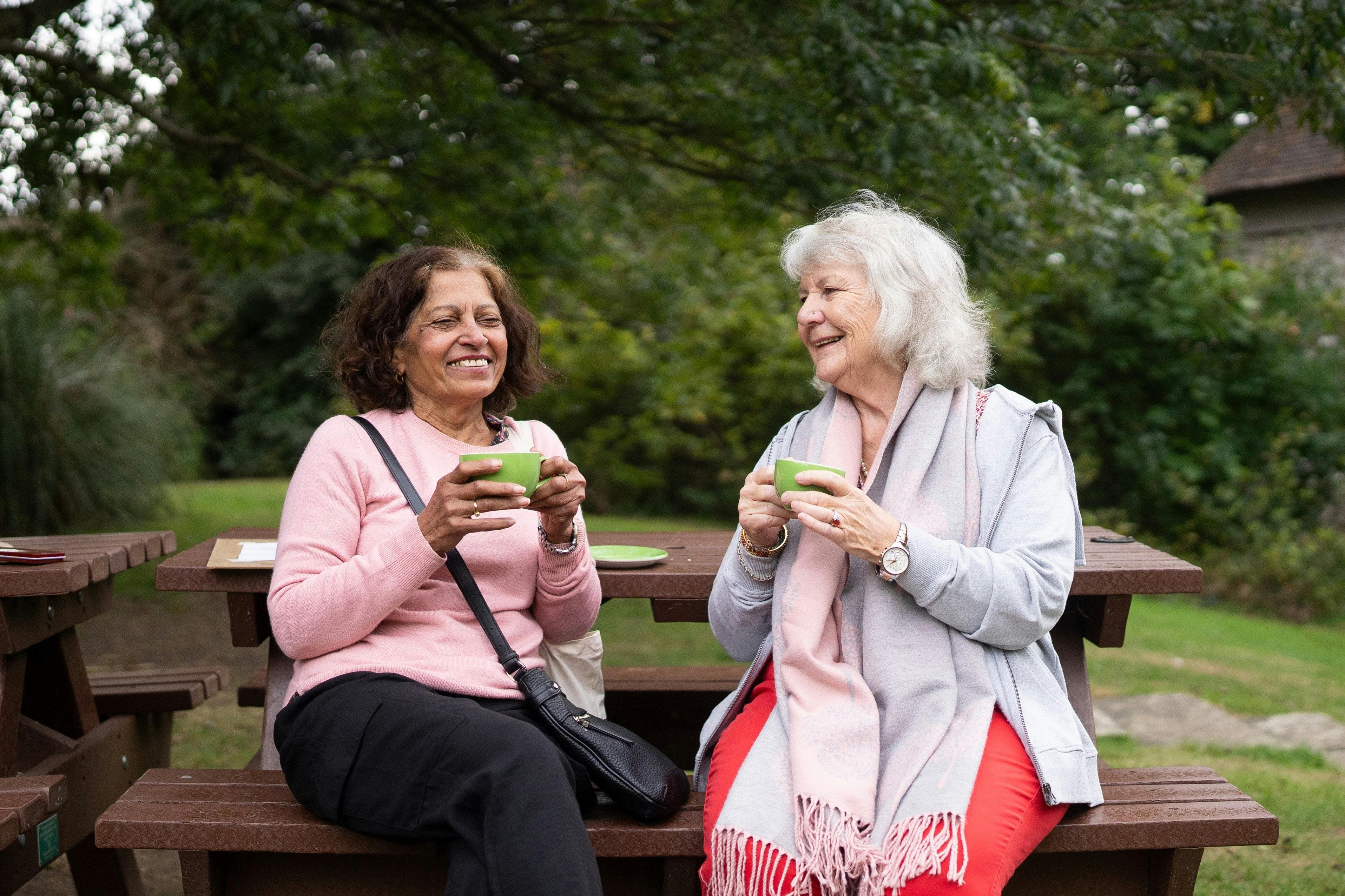 Two women laughing and connecting outdoors