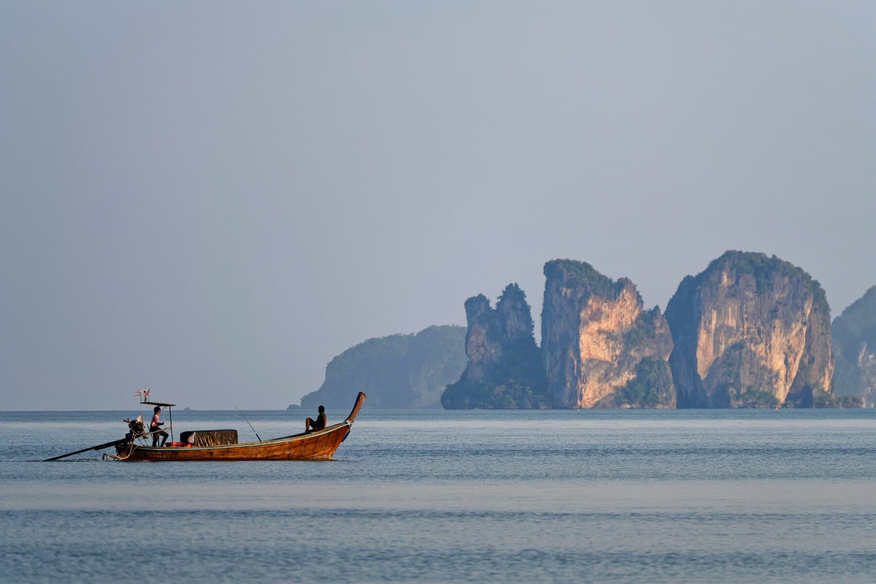 Longtail boat with Krabi limestone cliffs
